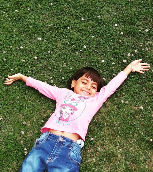 image of a girl lying on the grass